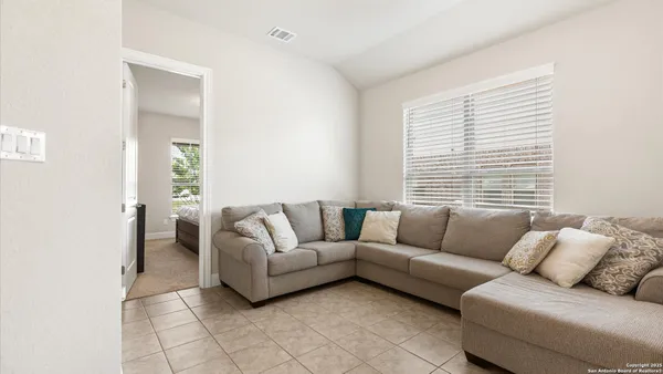 a living room with furniture and a large window