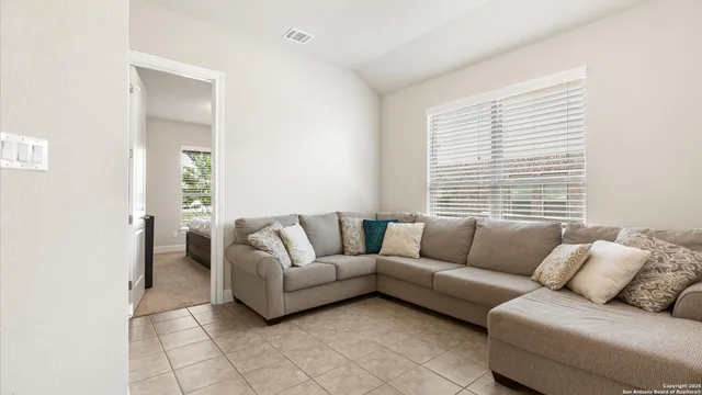 a living room with furniture and a large window