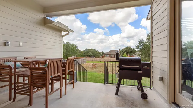 a view of a chairs and table in the balcony