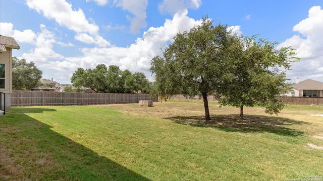 a swimming pool with trees in the background