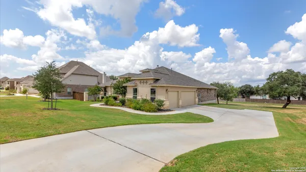 a front view of house with yard and green space