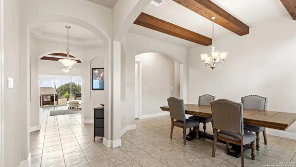 a view of a dining room with furniture and a chandelier