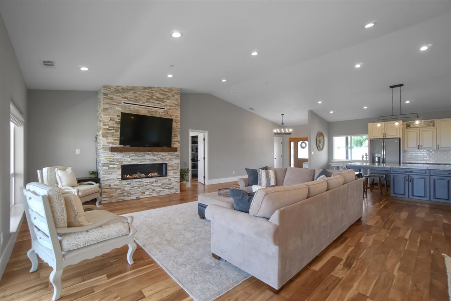 7991 South Shingle Road Shingle Springs, CA 95682 - Photo 16 of 58 a living room with furniture a fireplace and a flat screen tv