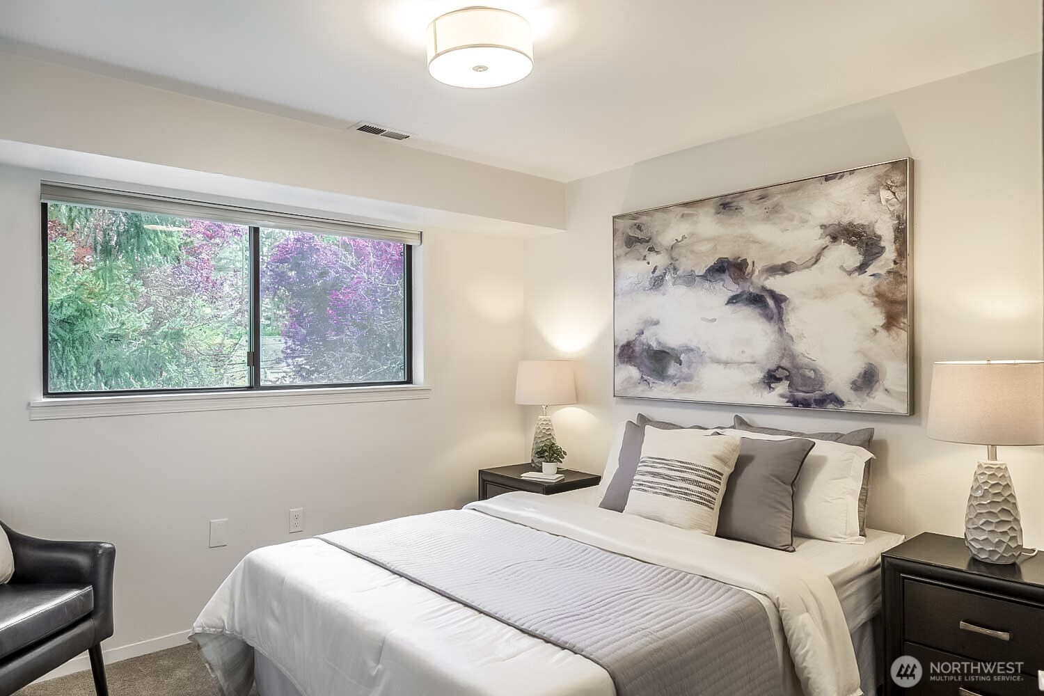 912 Northeast 115th Street Seattle, WA 98125 - Photo 16 of 21 a bedroom with a bed and a painting on the wall