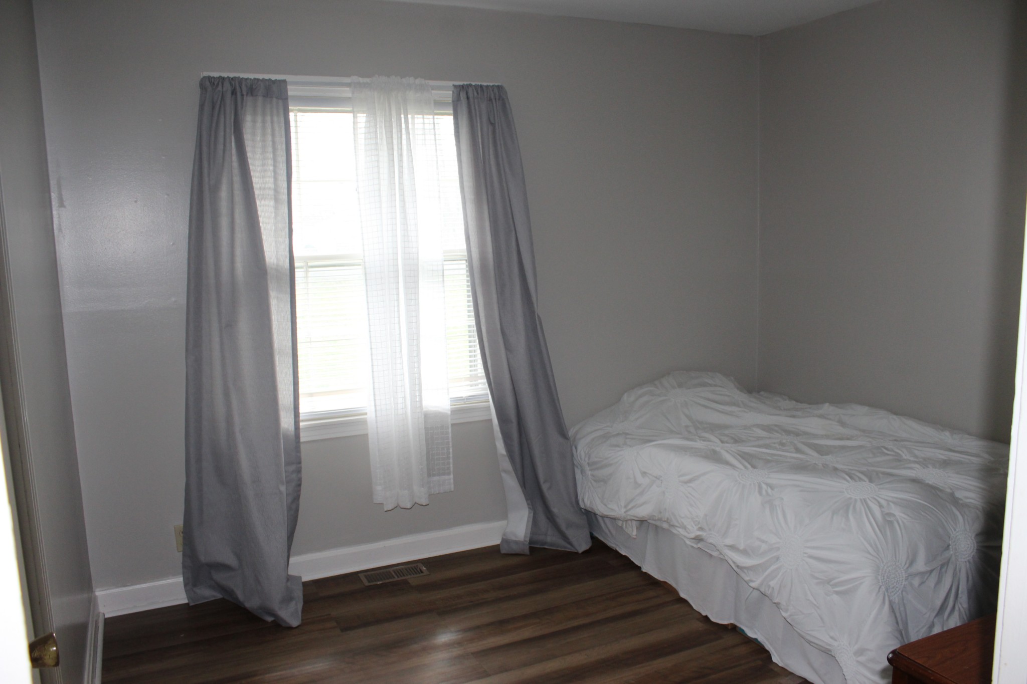 317 Pitt Lane Springfield, TN 37172 - Photo 12 of 22 a bed sitting in a bedroom next to a window