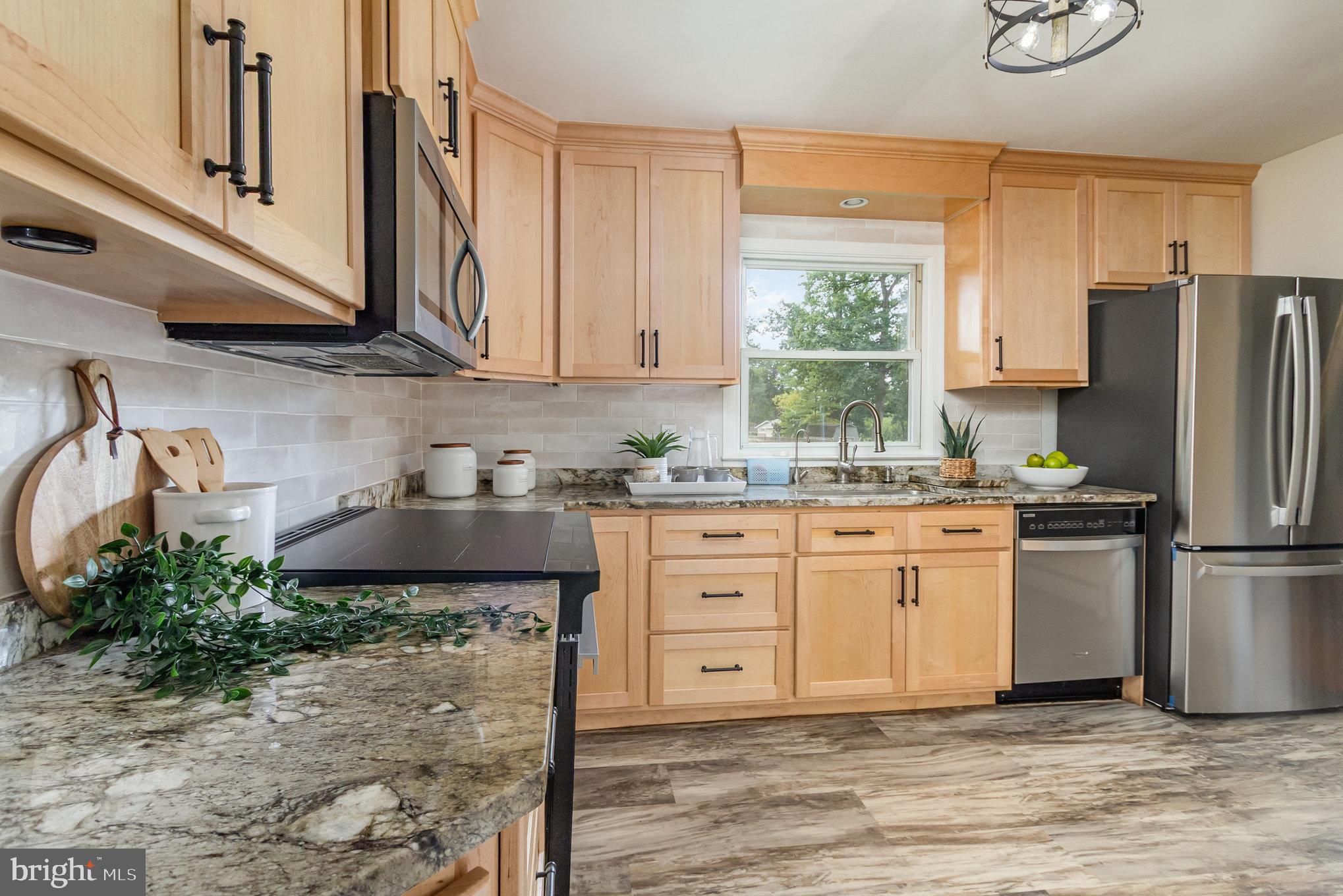 2507 Jerusalem Road Joppa, MD 21085 - Photo 18 of 50 a kitchen with stainless steel appliances granite countertop a refrigerator sink and cabinets