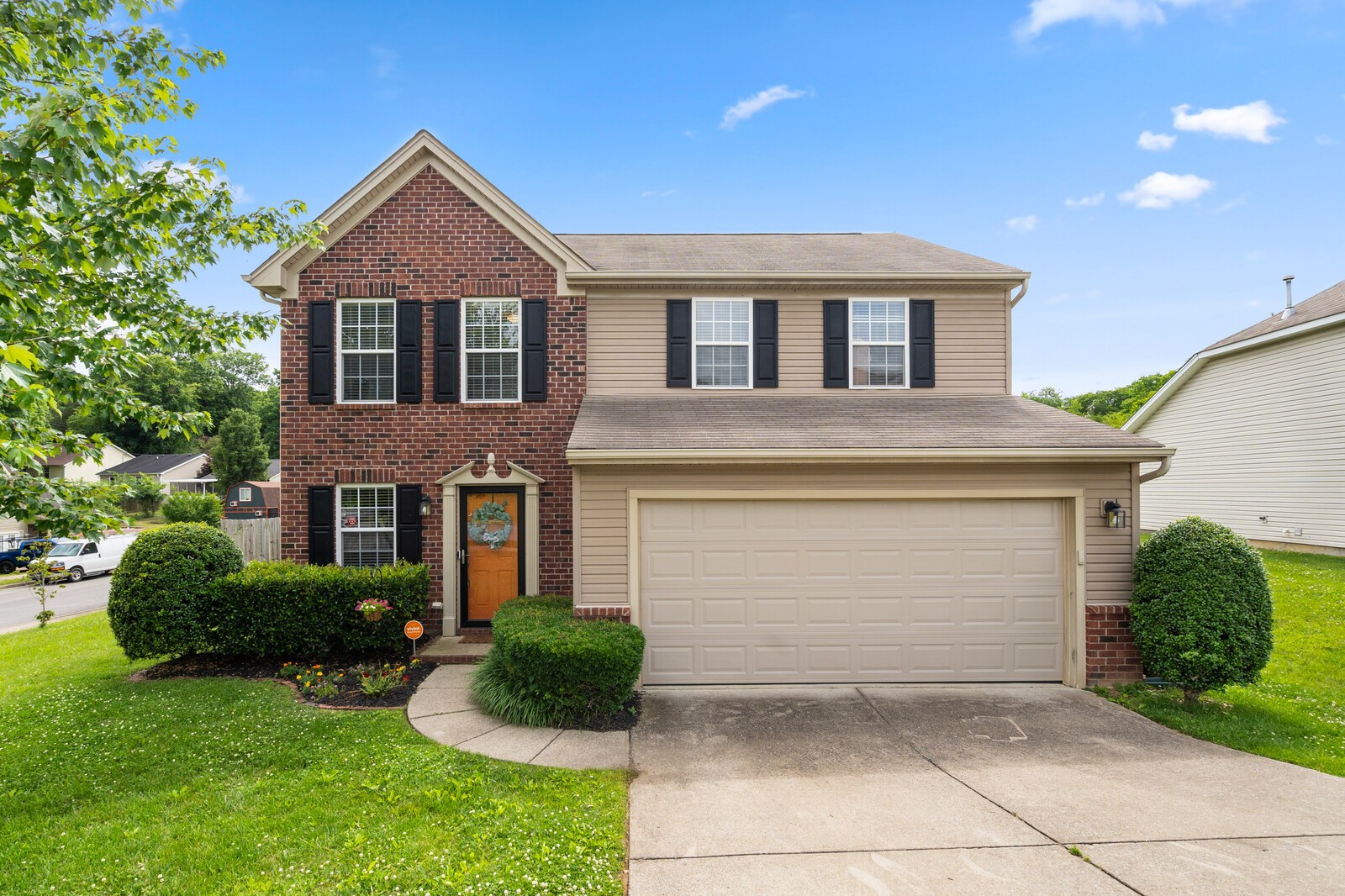 a front view of a house with a yard