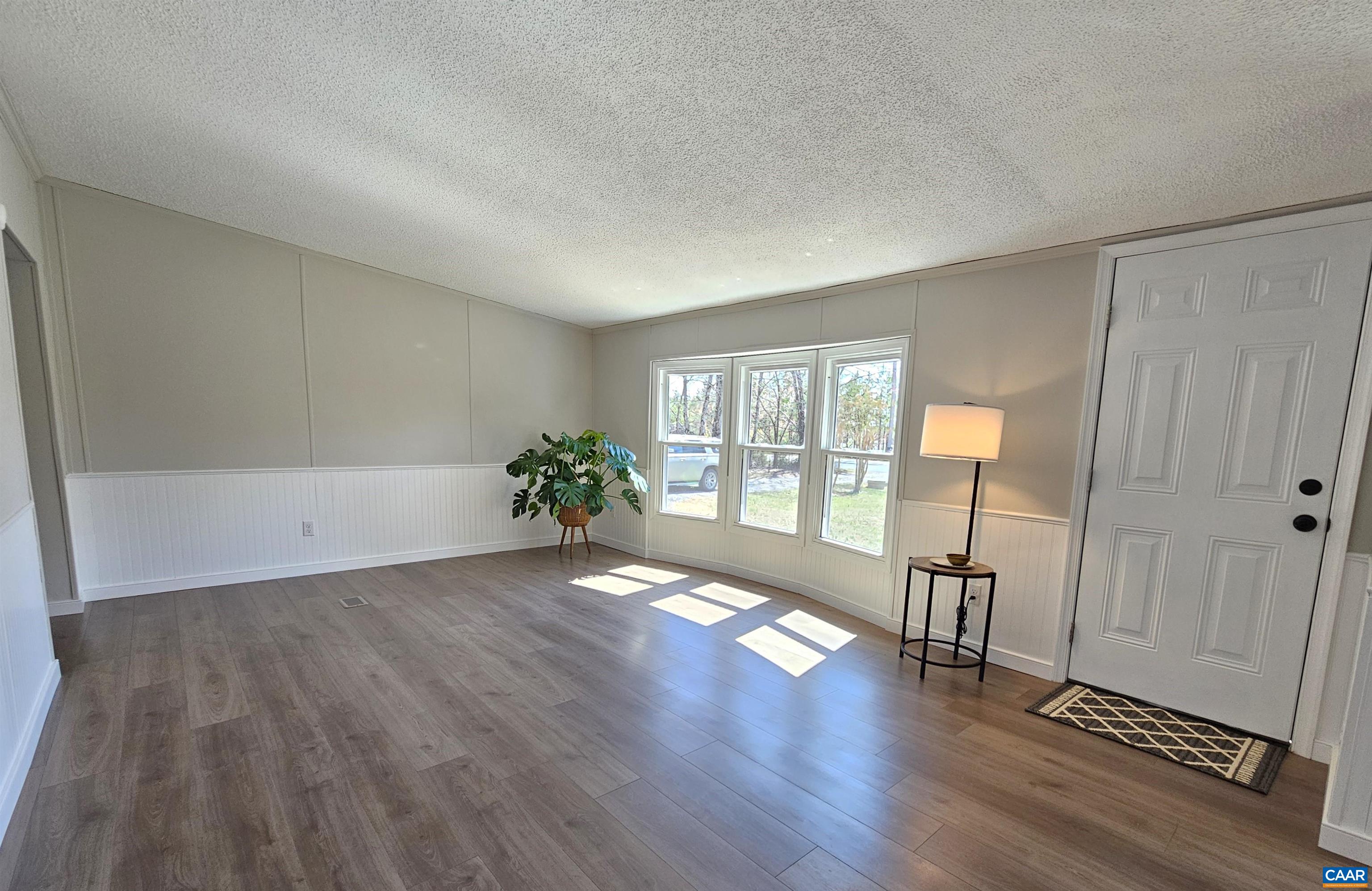 2711 Ranson Road Dillwyn, VA 23936 - Photo 3 of 30 a view of an empty room with a window and wooden floor