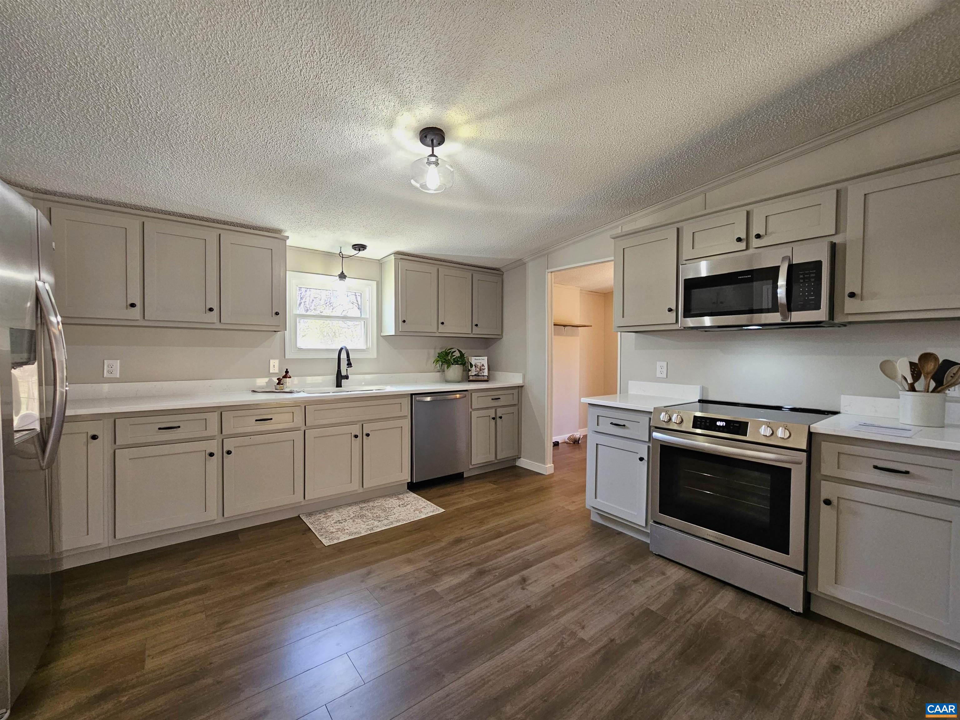 2711 Ranson Road Dillwyn, VA 23936 - Photo 6 of 30 a kitchen with granite countertop a sink cabinets and stainless steel appliances