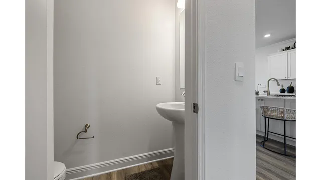 a kitchen with sink cabinets and wooden floor