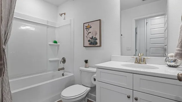 a bathroom with a granite countertop sink and toilet