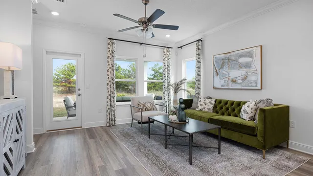a living room with furniture and kitchen view