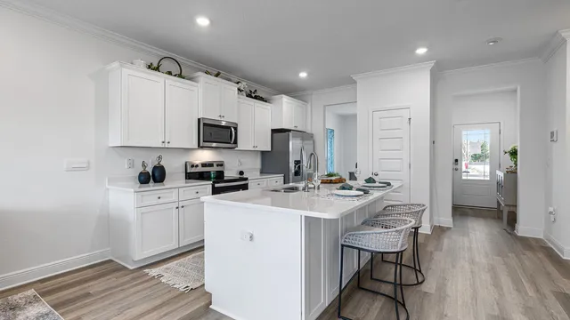 a kitchen with a sink stove and cabinets