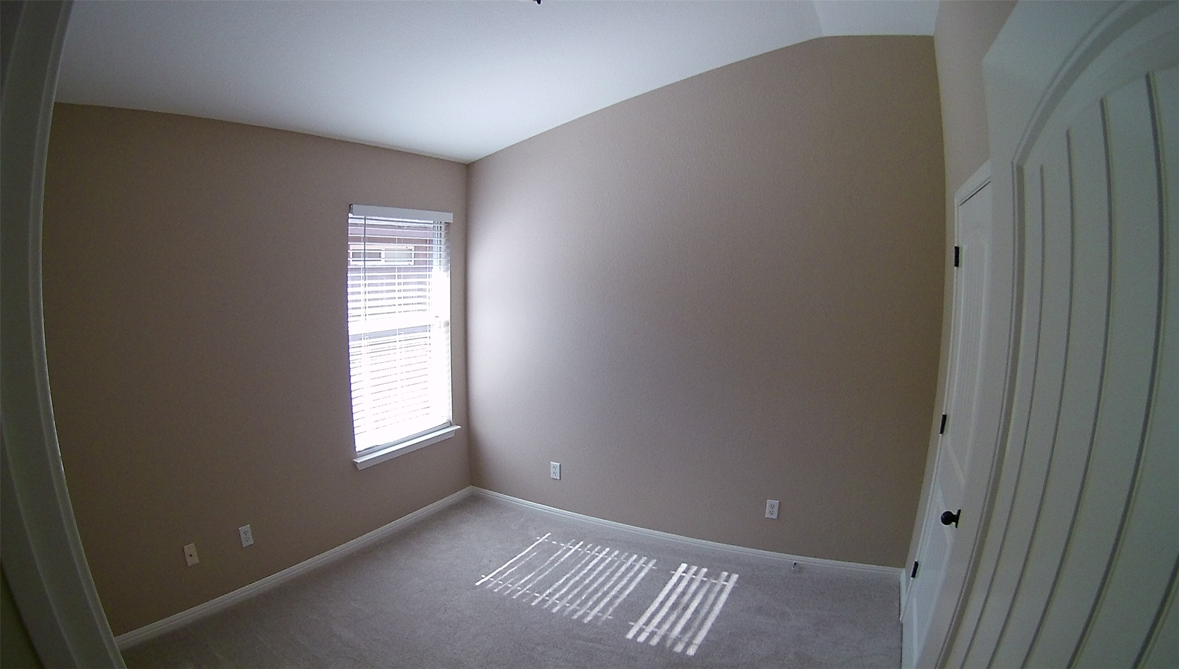 3304 Wickham Lane Austin, TX 78725 - Photo 9 of 13 Carpeted empty room featuring baseboards and vaulted ceiling