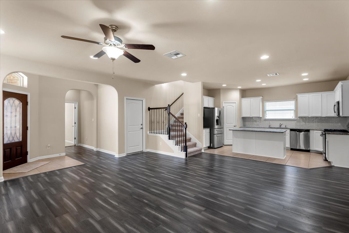 3451 Mayfield Ranch Boulevard, Unit 311 Round Rock, TX 78681 - Photo 7 of 40 Open-concept living area featuring dark wood-finish flooring, recessed lighting, and a ceiling fan