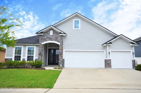 a front view of a house with a yard and garage