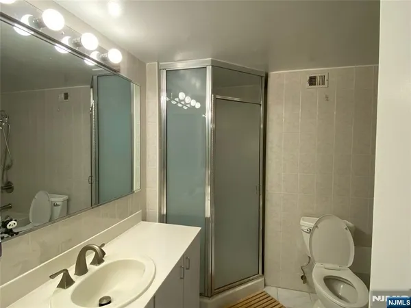 a bathroom with a toilet and shower