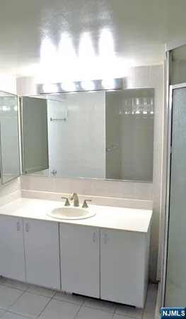 a white toilet sitting next to a bathroom sink and a tub