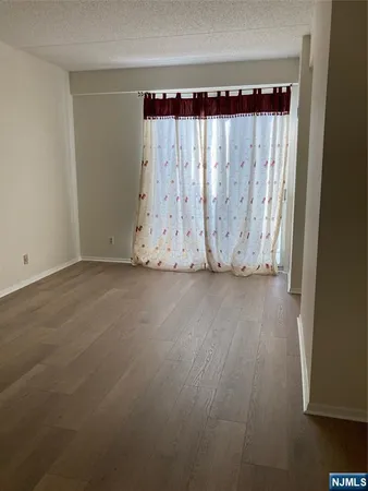 a view of a room with wooden floor and windows