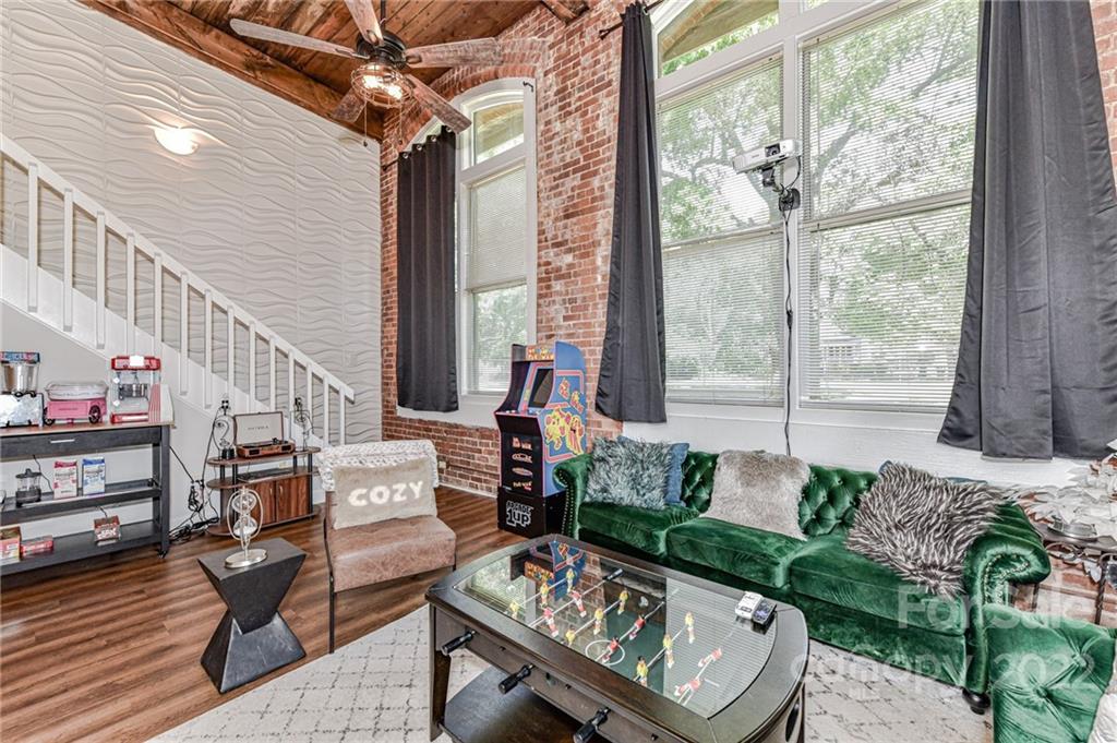 201 South Hoskins Road, Unit 106 Charlotte, NC 28208 - Photo 1 of 18 a living room with furniture and a floor to ceiling window