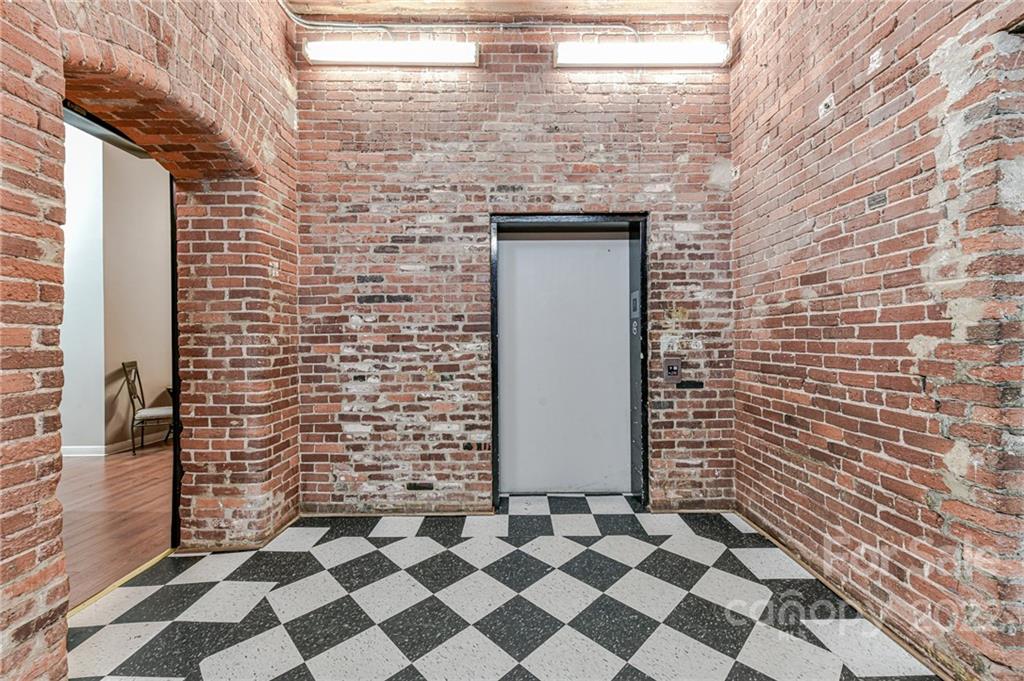 201 South Hoskins Road, Unit 106 Charlotte, NC 28208 - Photo 13 of 18 a brick building with a black white checkered floor