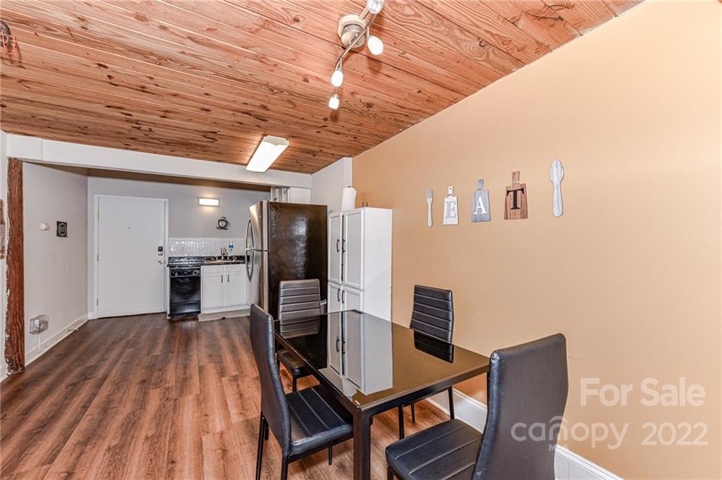 201 South Hoskins Road, Unit 106 Charlotte, NC 28208 - Photo 6 of 18 a view of a dining room with furniture and wooden floor