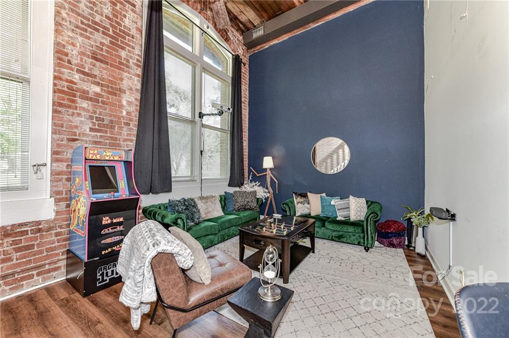 201 South Hoskins Road, Unit 106 Charlotte, NC 28208 - Photo 7 of 18 a living room with furniture and a large window