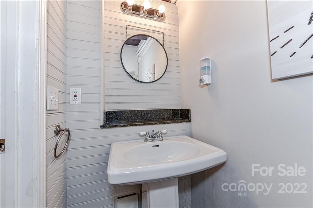 201 South Hoskins Road, Unit 106 Charlotte, NC 28208 - Photo 10 of 18 a bathroom with a sink and a mirror