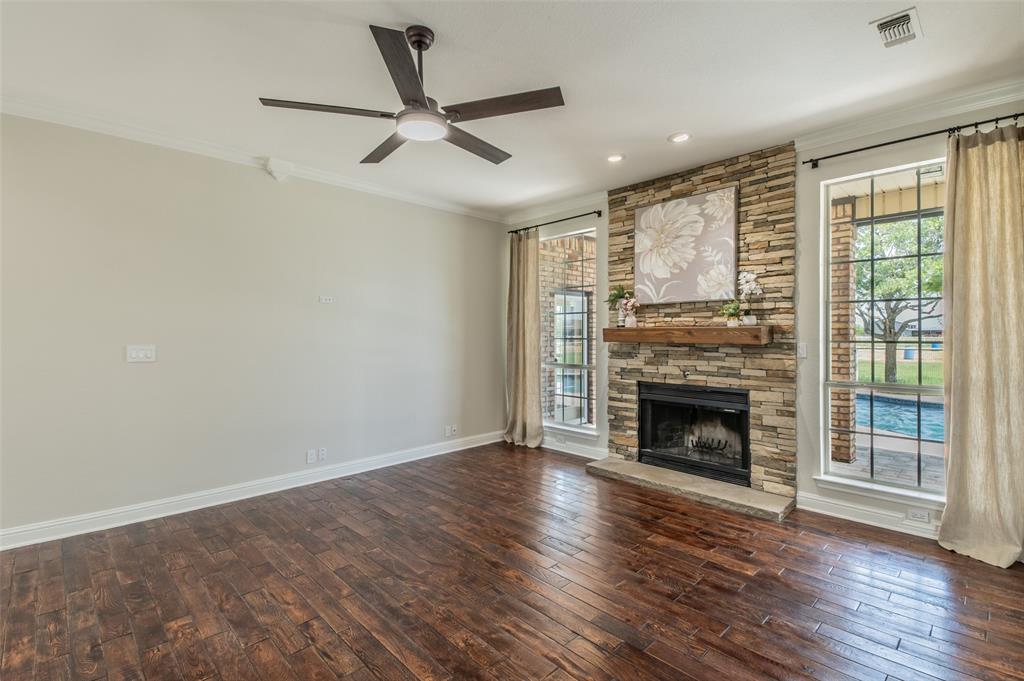 13507 Friendship Road Pilot Point, TX 76258 - Photo 5 of 39 a view of a livingroom with a fireplace a ceiling fan and wooden floor