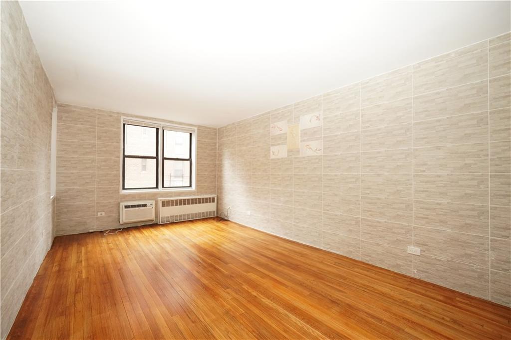 345 Webster Avenue, Unit 3N Brooklyn, NY 11230 - Photo 7 of 10 wooden floor in an empty room with a window