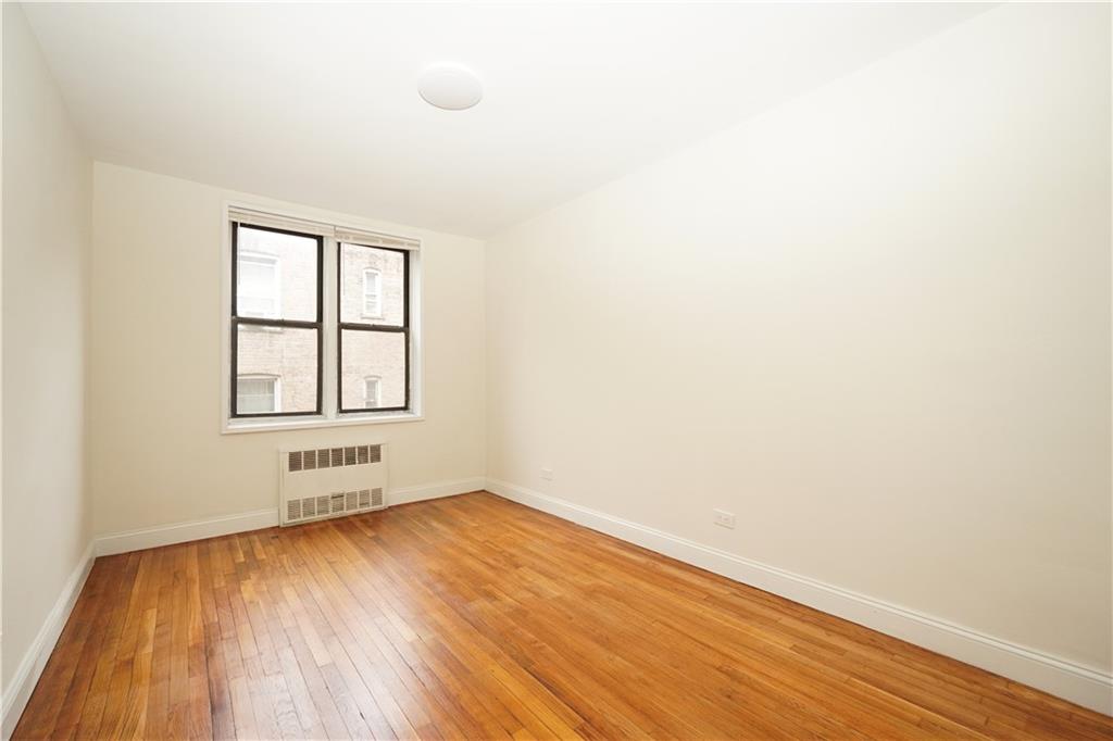 345 Webster Avenue, Unit 3N Brooklyn, NY 11230 - Photo 8 of 10 an empty room with wooden floor and windows