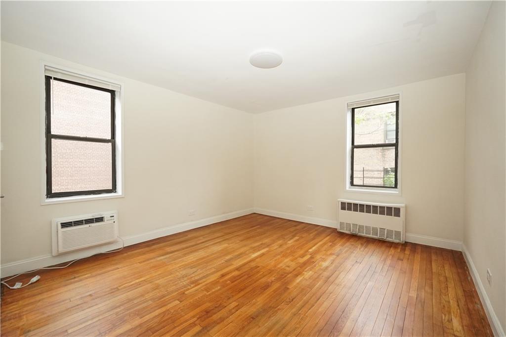 345 Webster Avenue, Unit 3N Brooklyn, NY 11230 - Photo 9 of 10 an empty room with wooden floor and windows
