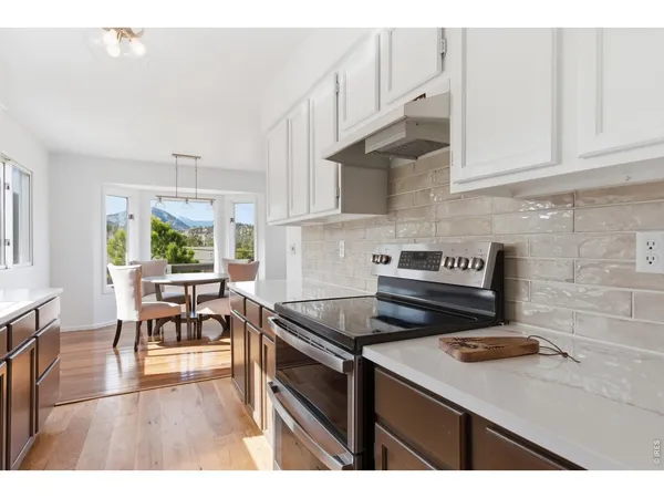 a kitchen with a sink a refrigerator a window and a counter top space