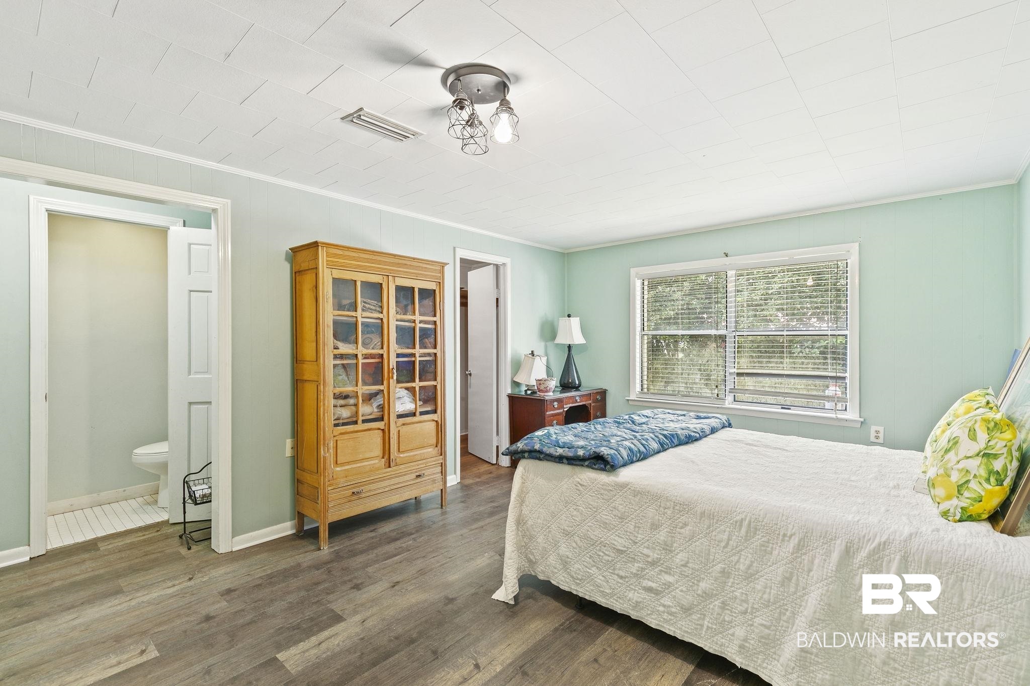 316 West Orchid Avenue Foley, AL 36535 - Photo 19 of 38 Bedroom with dark wood-style flooring, crown molding, and ensuite bath