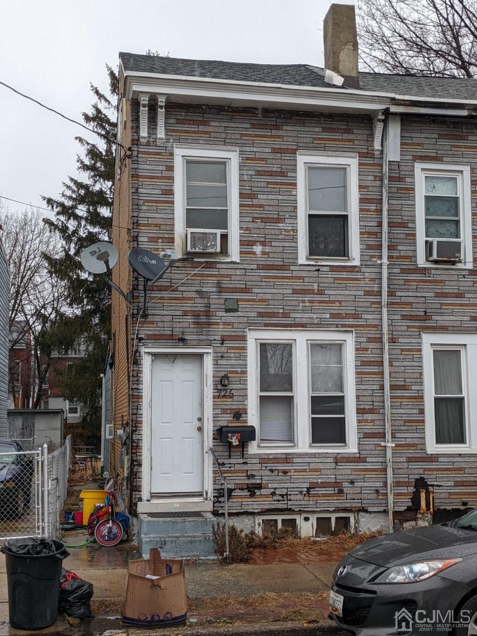 a front view of a house with outdoor seating