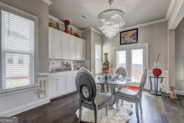 a living room with furniture and two window