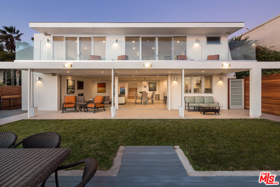 a view of a house with swimming pool and porch