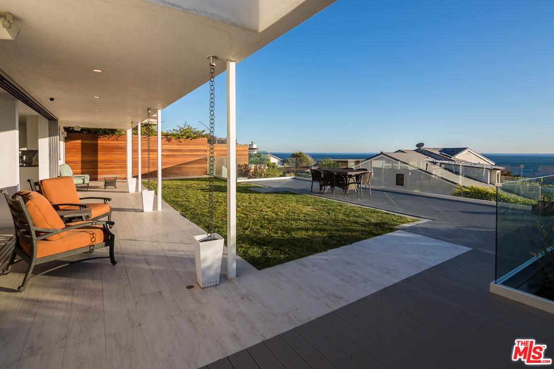 31528 Broad Beach Road Malibu, CA 90265 - Photo 17 of 26 a view of a swimming pool with a lounge chairs
