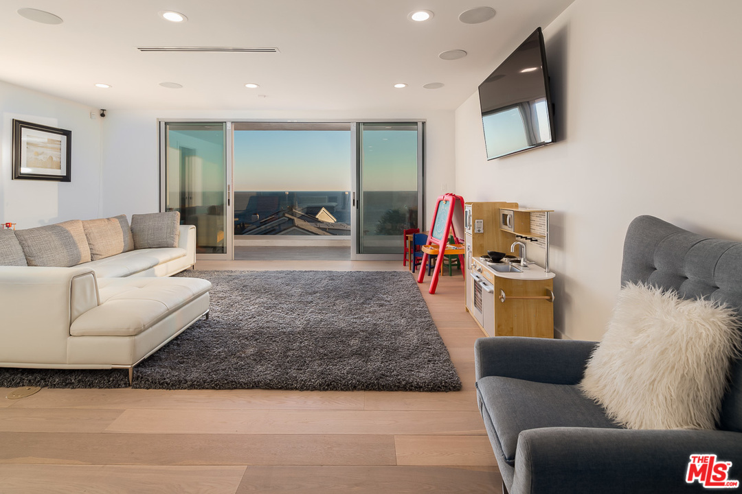31528 Broad Beach Road Malibu, CA 90265 - Photo 19 of 26 a living room with furniture and a flat screen tv
