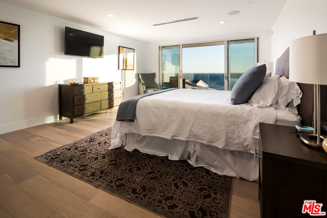 31528 Broad Beach Road Malibu, CA 90265 - Photo 20 of 26 a bed room with a bed window and a flat screen tv