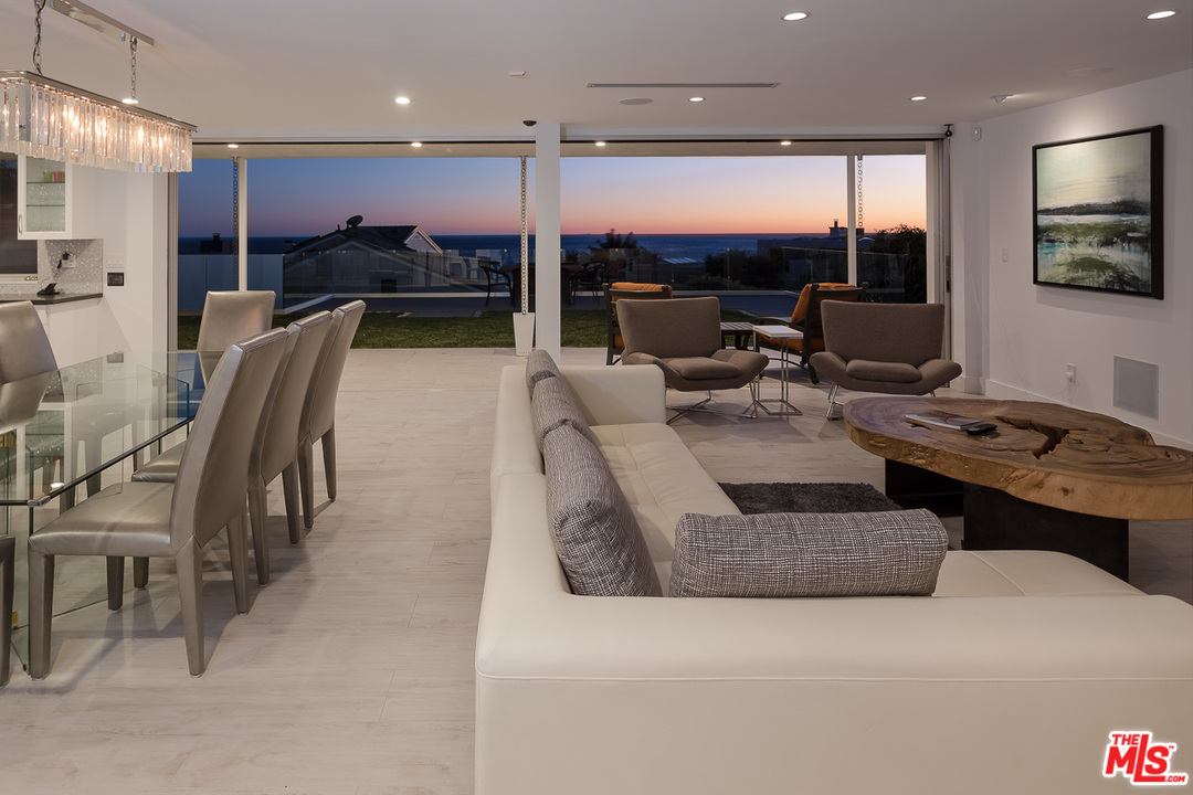 31528 Broad Beach Road Malibu, CA 90265 - Photo 3 of 26 a large living room with stainless steel appliances kitchen island furniture a flat screen tv and a large window