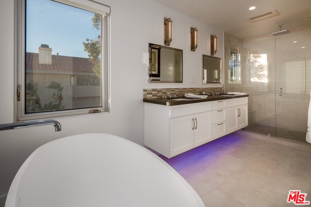 31528 Broad Beach Road Malibu, CA 90265 - Photo 22 of 26 a bathroom with a granite countertop double vanity sink a mirror and a shower