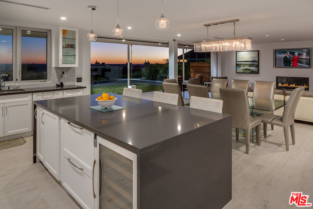 31528 Broad Beach Road Malibu, CA 90265 - Photo 4 of 26 an open kitchen with granite countertop a table and chairs