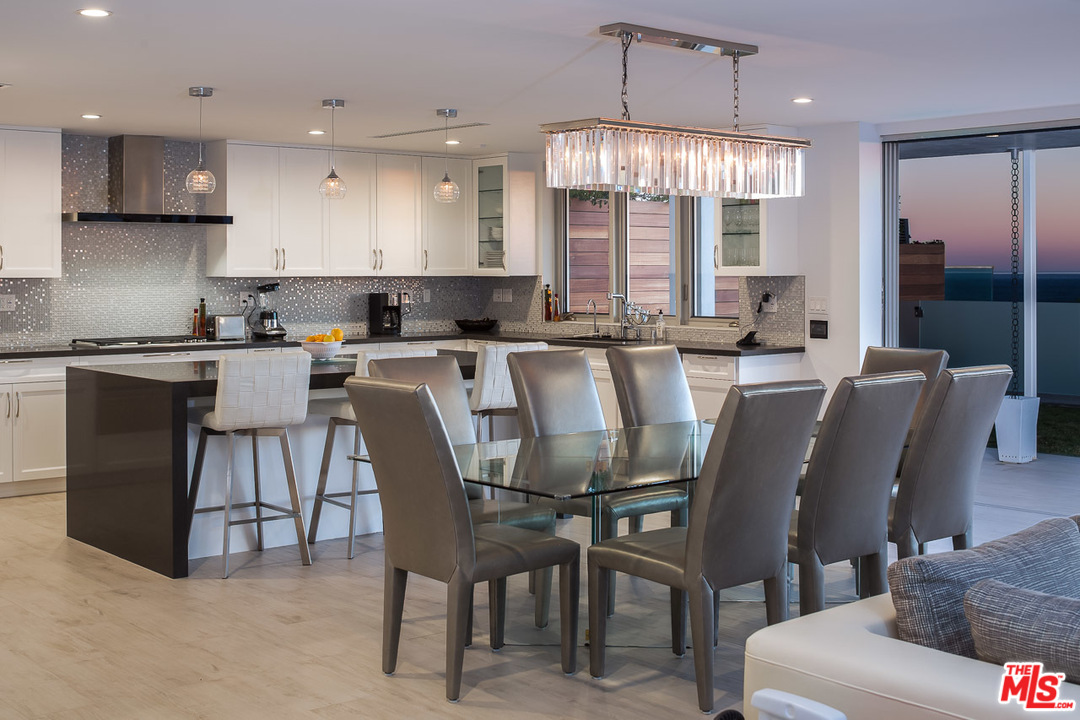 31528 Broad Beach Road Malibu, CA 90265 - Photo 5 of 26 a large kitchen with a table and chairs