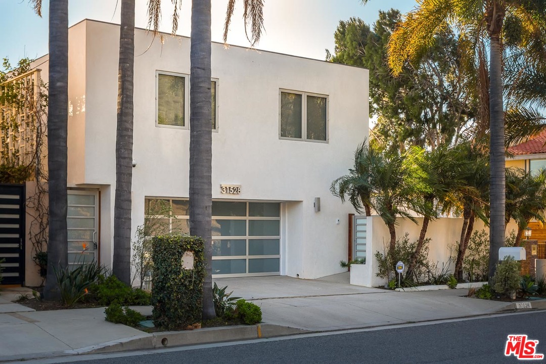 31528 Broad Beach Road Malibu, CA 90265 - Photo 9 of 26 a palm tree in front of a house