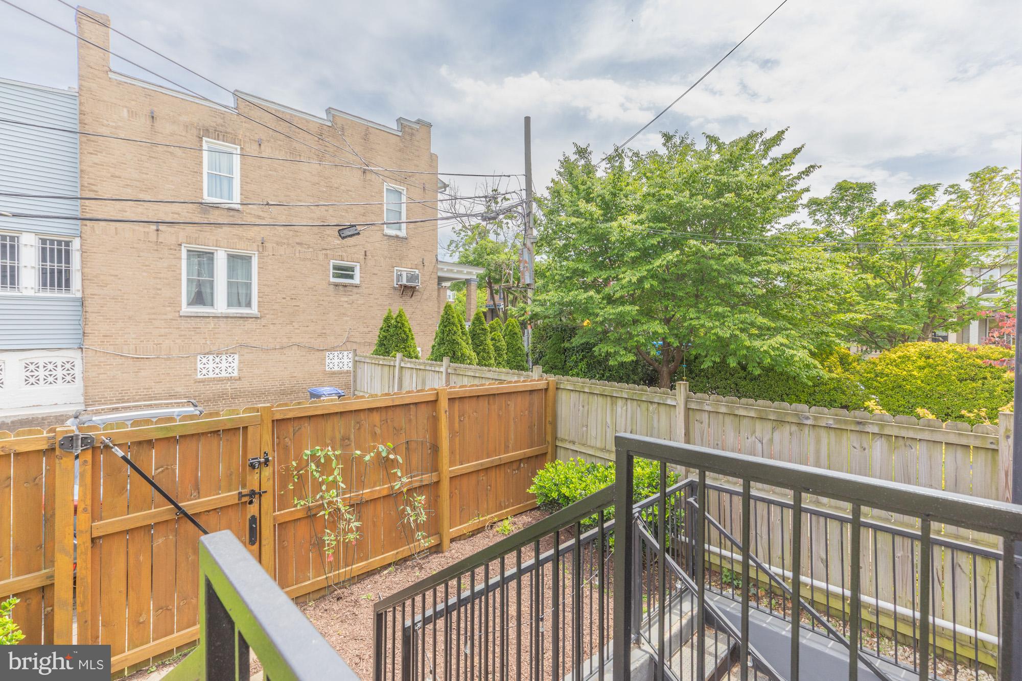 3803 10th Street Northwest, Unit 1 Washington, DC 20011 - Photo 36 of 71 a view of a balcony with wooden floor and fence