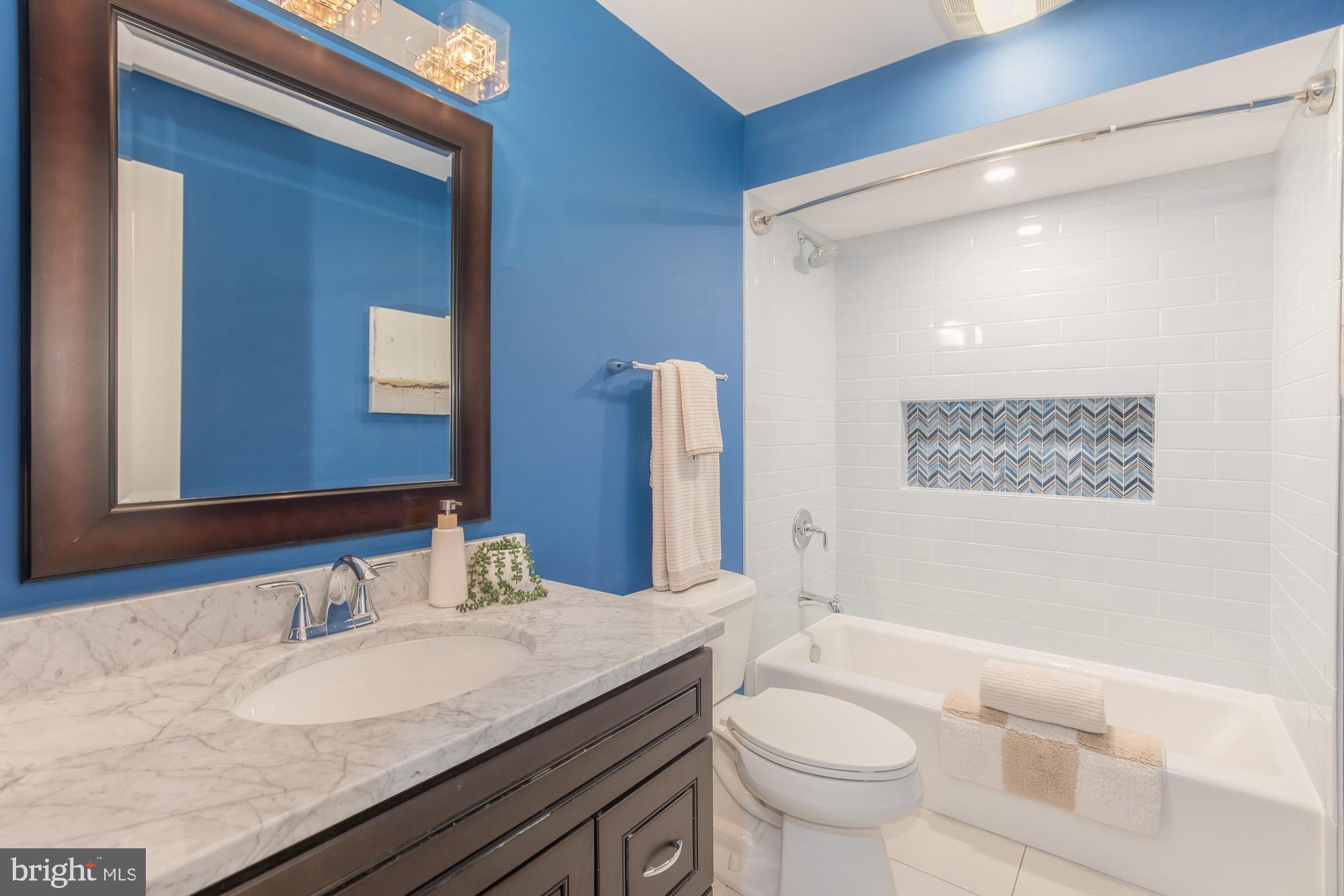 3803 10th Street Northwest, Unit 1 Washington, DC 20011 - Photo 47 of 71 a bathroom with a granite countertop sink a toilet and a mirror
