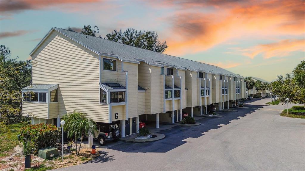1500 Sunset Road, Unit G4 Tarpon Springs, FL 34689 - Photo 1 of 44 a group of cars parked in front of a house