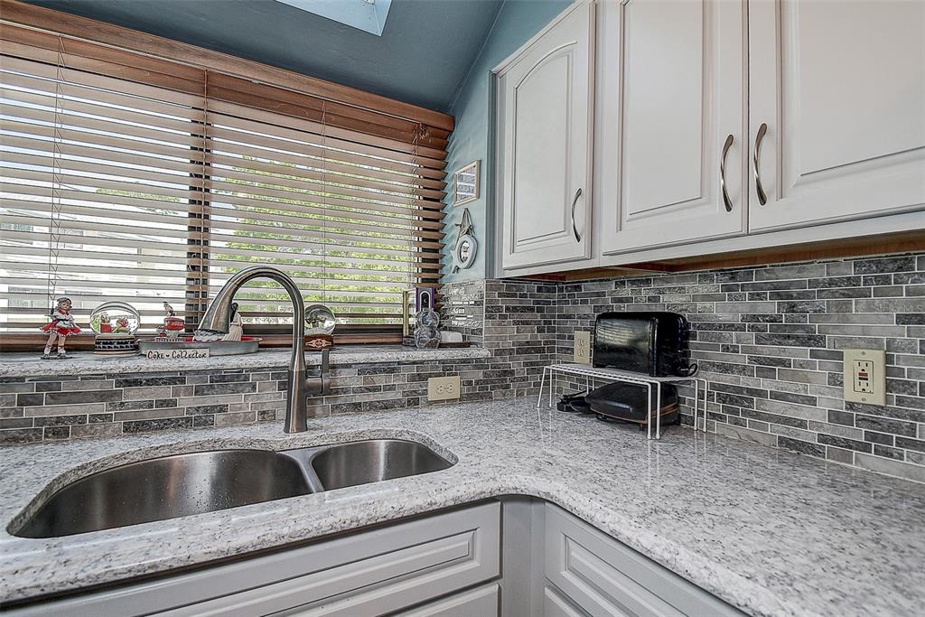 1500 Sunset Road, Unit G4 Tarpon Springs, FL 34689 - Photo 15 of 44 a kitchen with a sink cabinets and a window