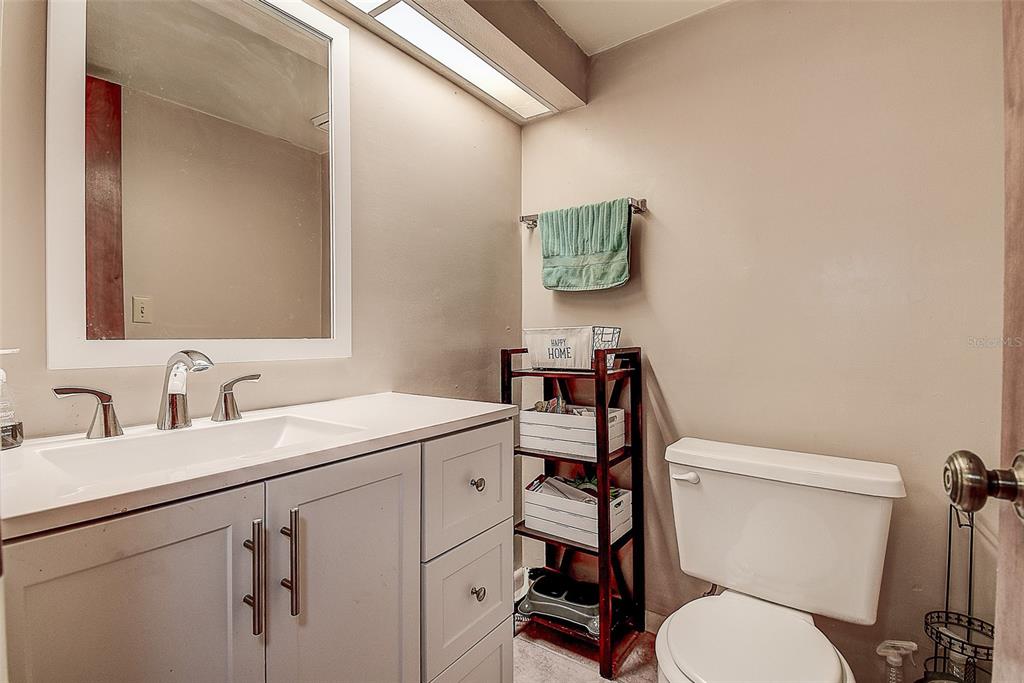 1500 Sunset Road, Unit G4 Tarpon Springs, FL 34689 - Photo 21 of 44 a bathroom with a toilet sink and mirror